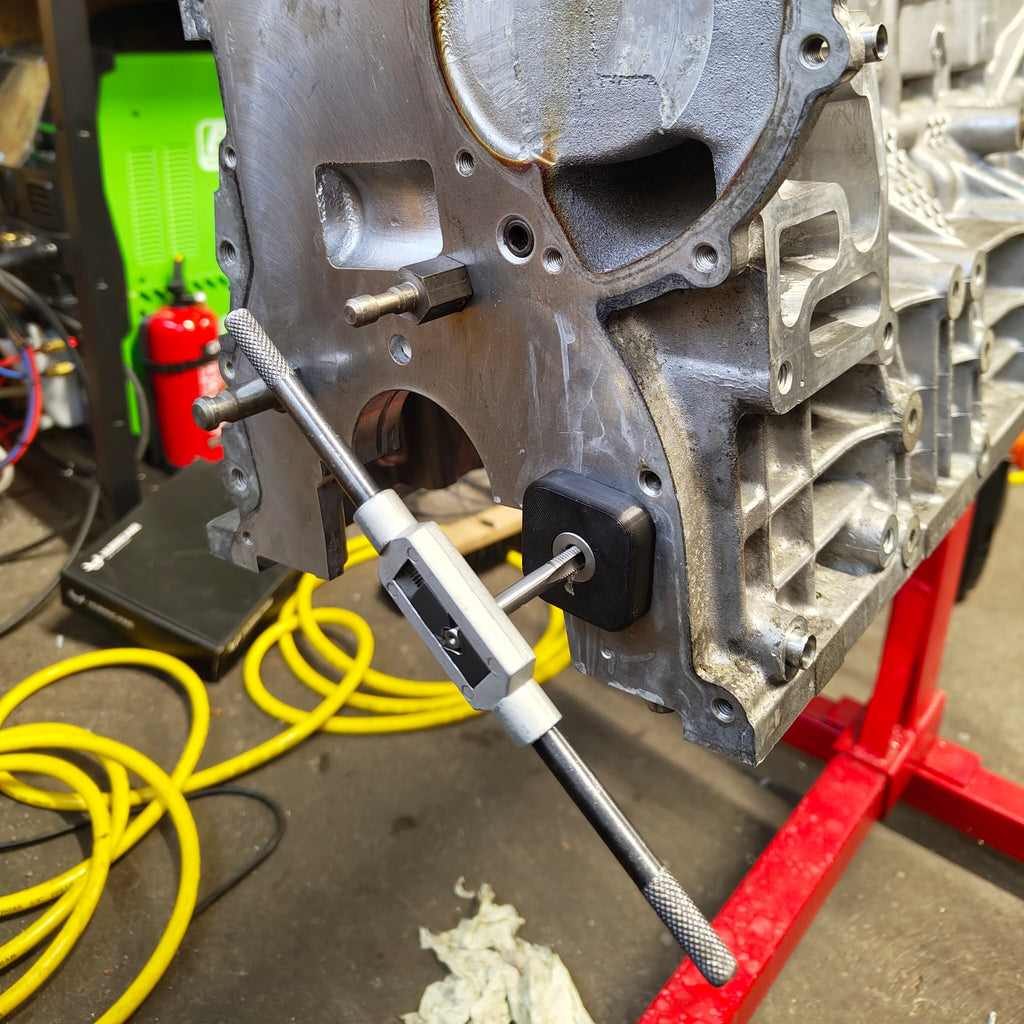 Tapping the tensioner mounting hole through the tap guide